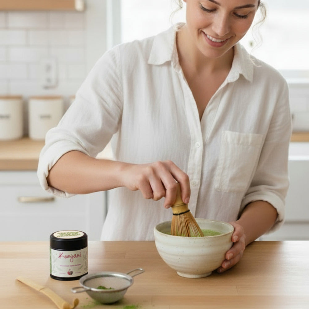 Woman preparing a organic ceremonial grade matcha in a kitchen