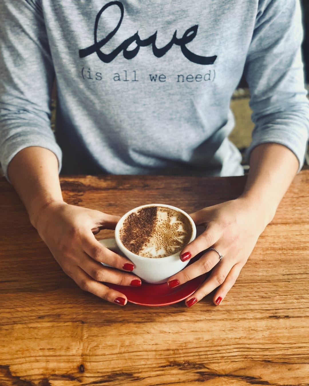 a cup of coffee on a wooden table